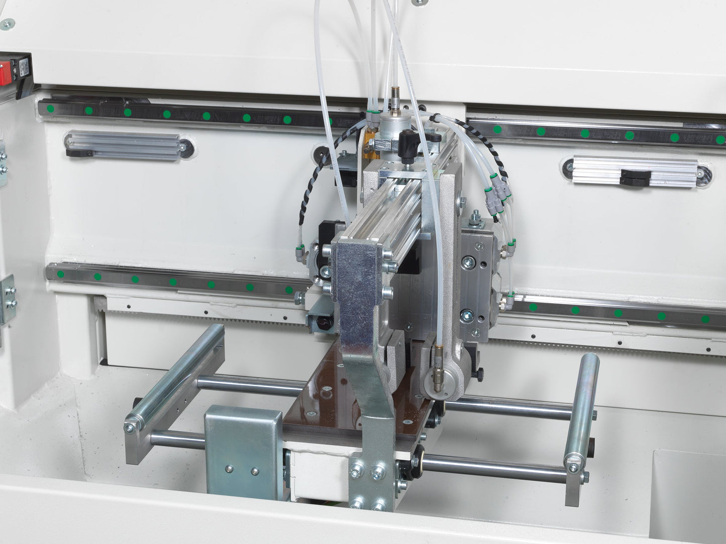 Close-up view of the cutting area of the Autocut machine, highlighting the precision blade and profile locking clamps.