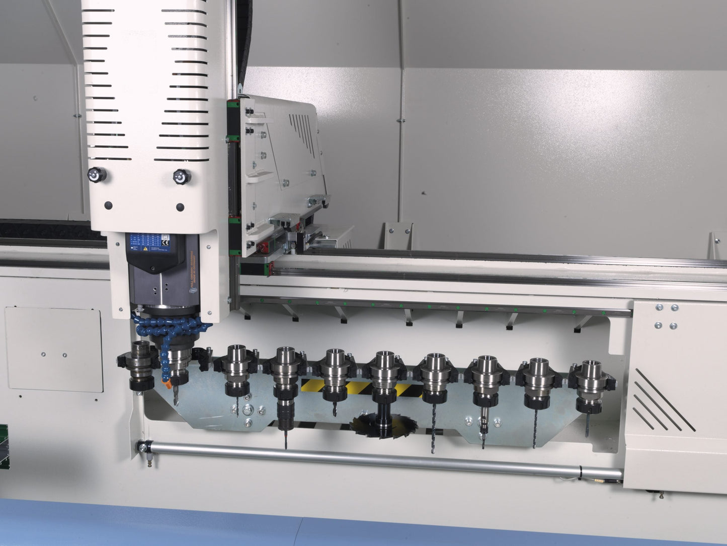 Close-up of the Rumba CNC machining center's electrospindle and automatic tool changer with 10 tool holders for precision milling and drilling.