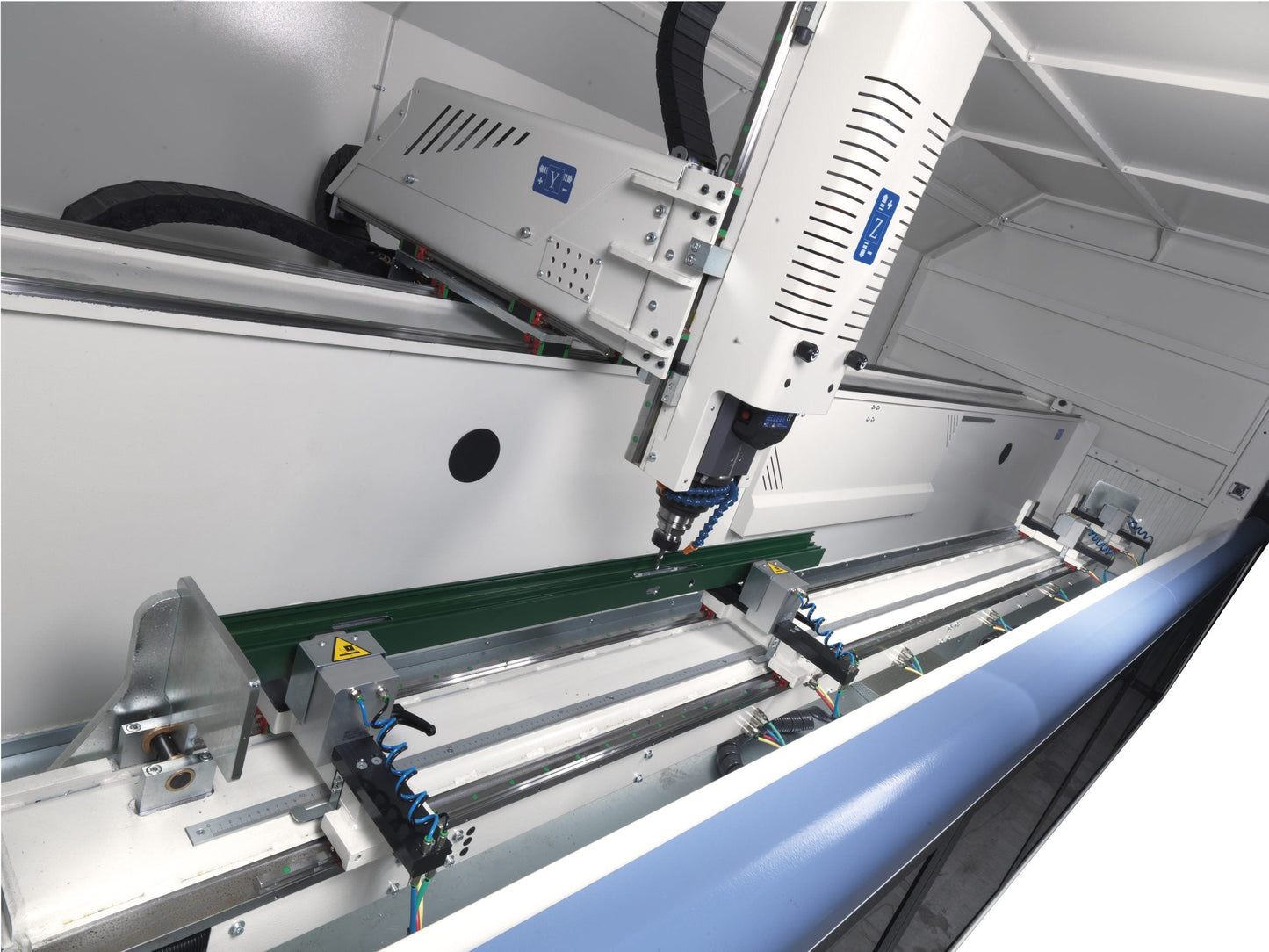 Interior view of the Rumba CNC machining center, showcasing the electrospindle, Y-axis movement, and pneumatic clamps for precise machining.