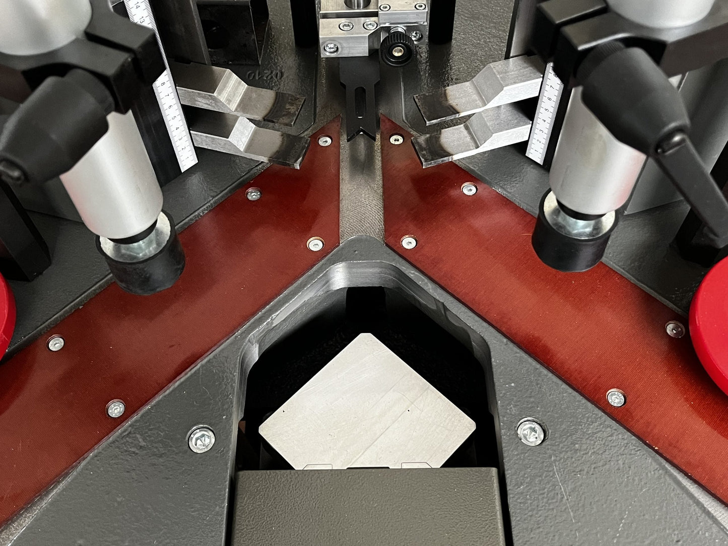 Overhead view of the Vectra crimping machine, showing the foot pedal controls and ergonomic design for aluminum profile assembly.